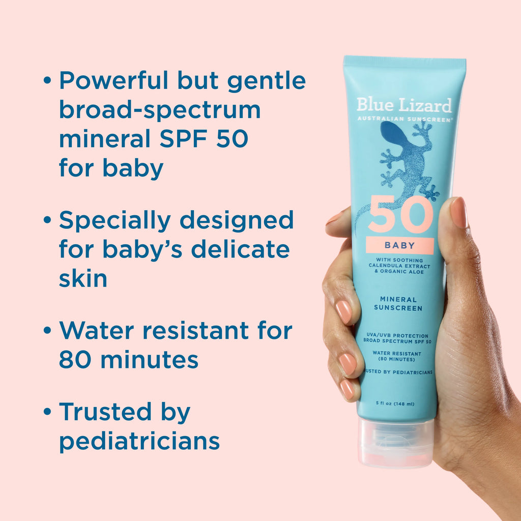 Blue Lizard Baby sunscreen tube held by a hand with product details on a pink background