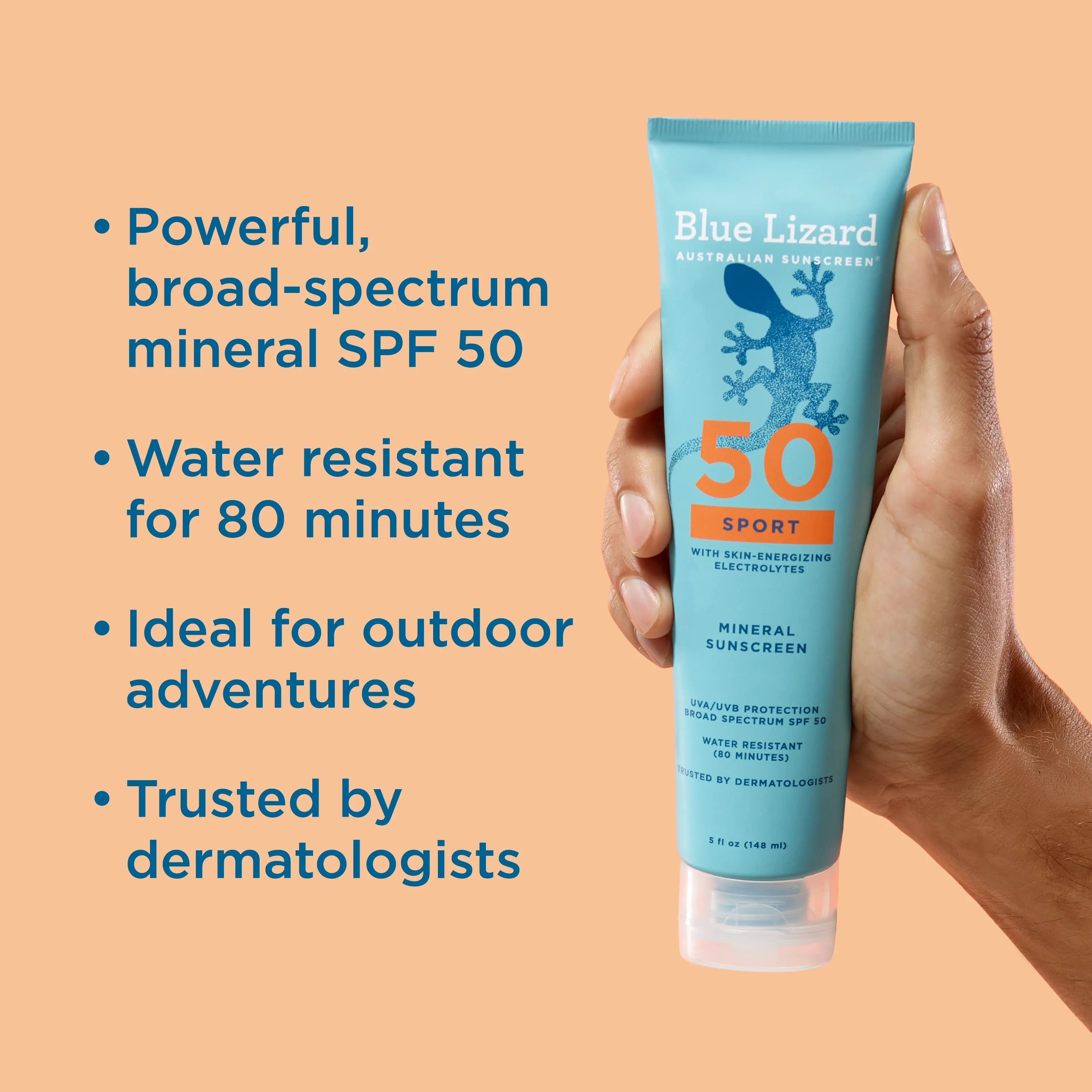 Hand holding a Blue Lizard Sport SPF 50 mineral sunscreen tube with product features listed on an orange background